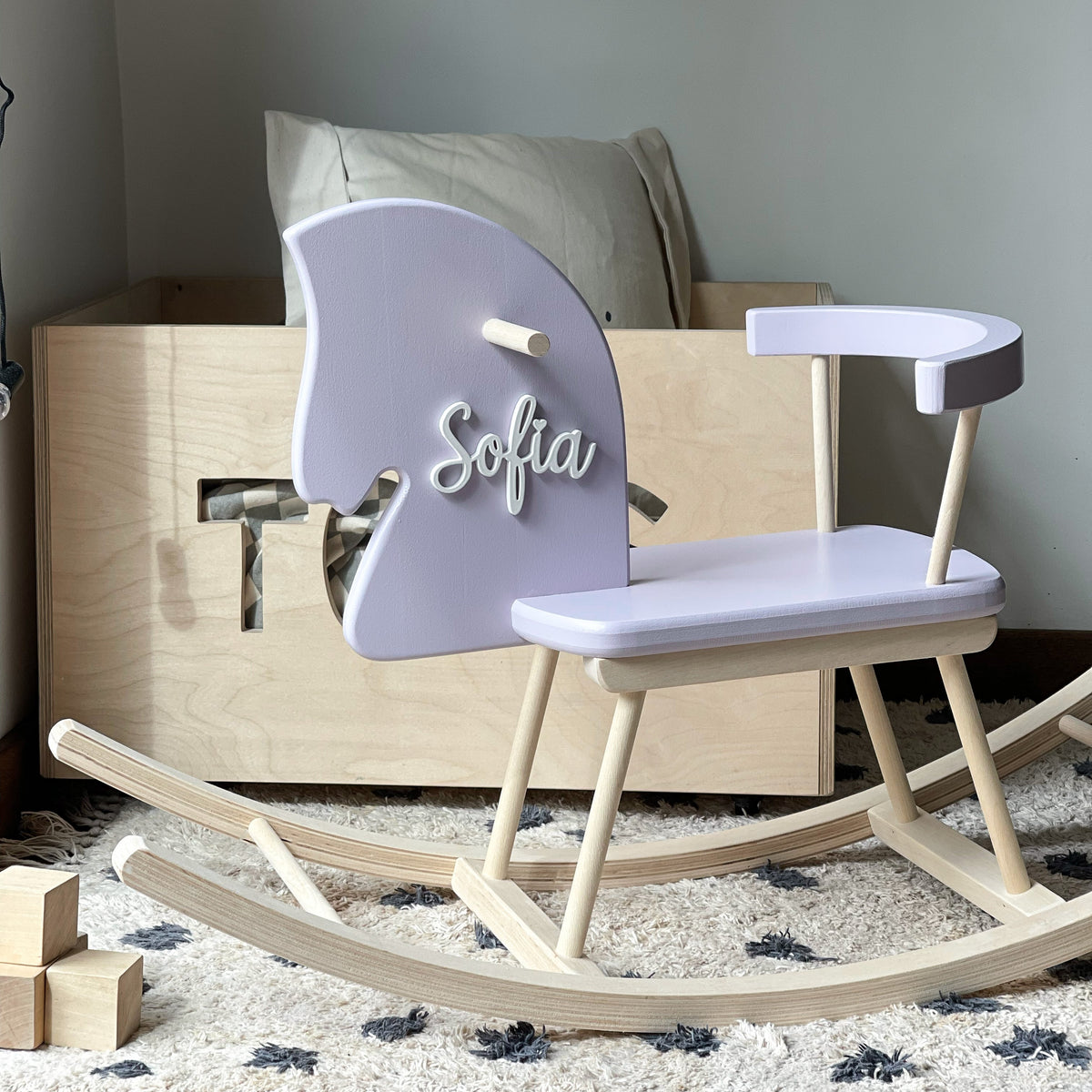 Children's rocking horse with 'Sofia' on a carpeted floor