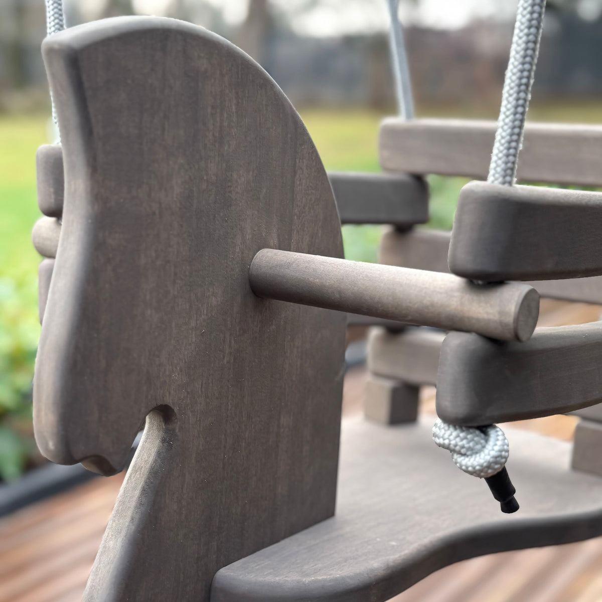 Close-up of a playground swing with a blurred background