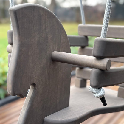 Close-up of a playground swing with a blurred background