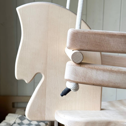 Wooden baby swing with a neutral background