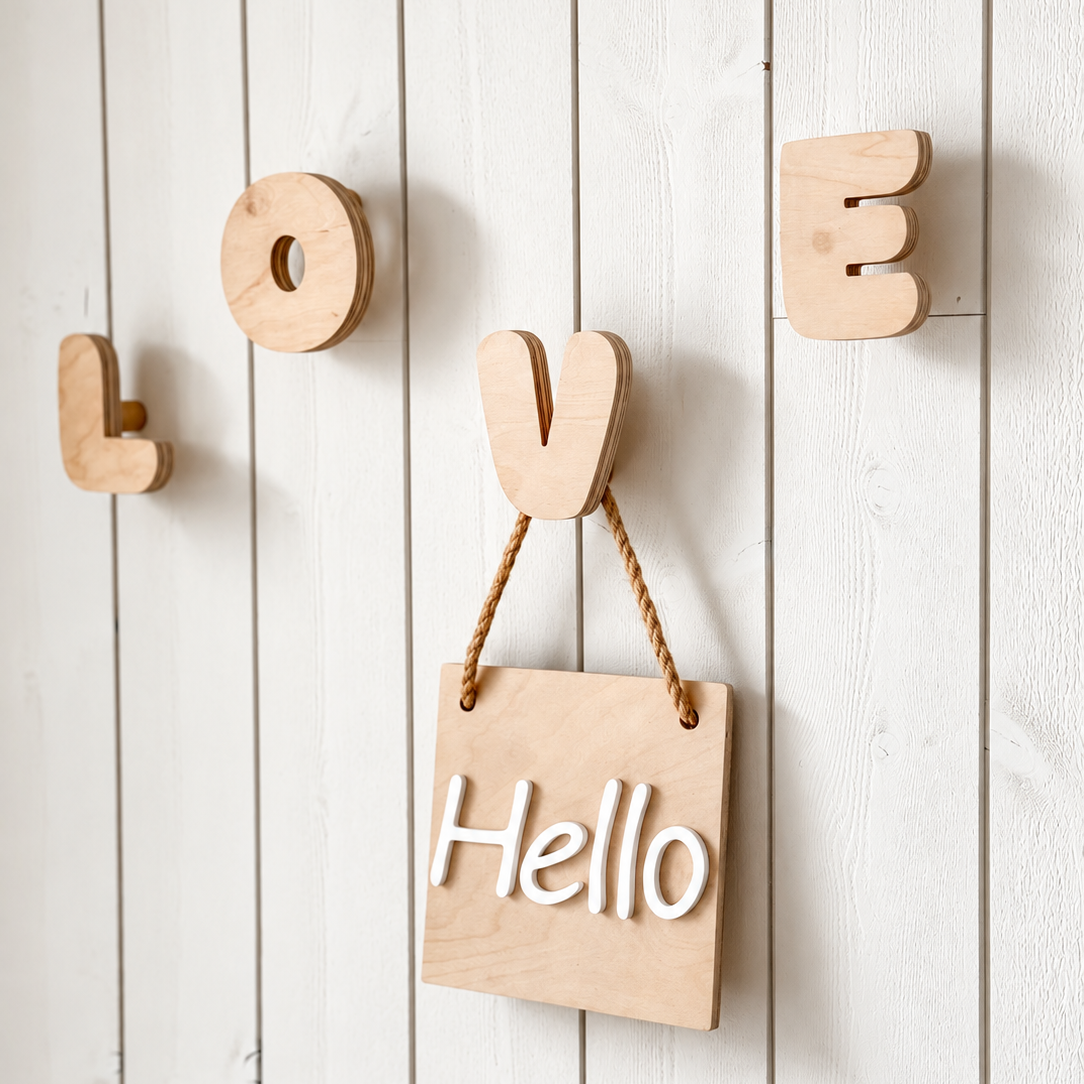 Natural wood wall decor featuring the word 'LOVE' with a hanging wooden sign that says 'Hello' on a white wood plank wall.